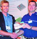 Paul van Jaarsveld, from Vodacom (left), won a Falcom Twist USB Modem Set in the RF Design competition. Andrew Hutton awards the prize